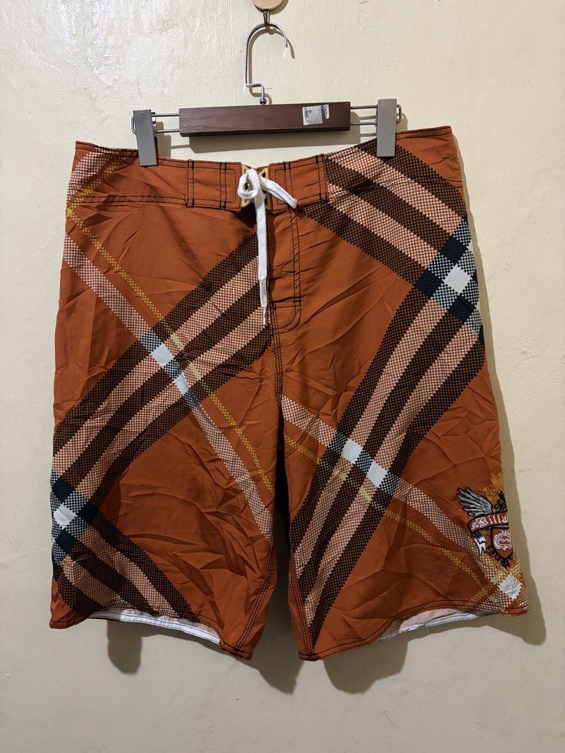 Billabong Board Shorts Orange Plaid Pattern (Category: Swim Trunks & Board Shorts) located in Bolinao. Submitted by ymondceleste (Listing ID 1460055555, Image 3). Description: - Orange board shorts with a classic plaid pattern. - Features the iconic Billabong logo embroidered on the pocket and back. - Comfortable drawstring waist for a secure fit. - Convenient back pocket with a button closure. - Ideal for swimming, surfing, or everyday casual we