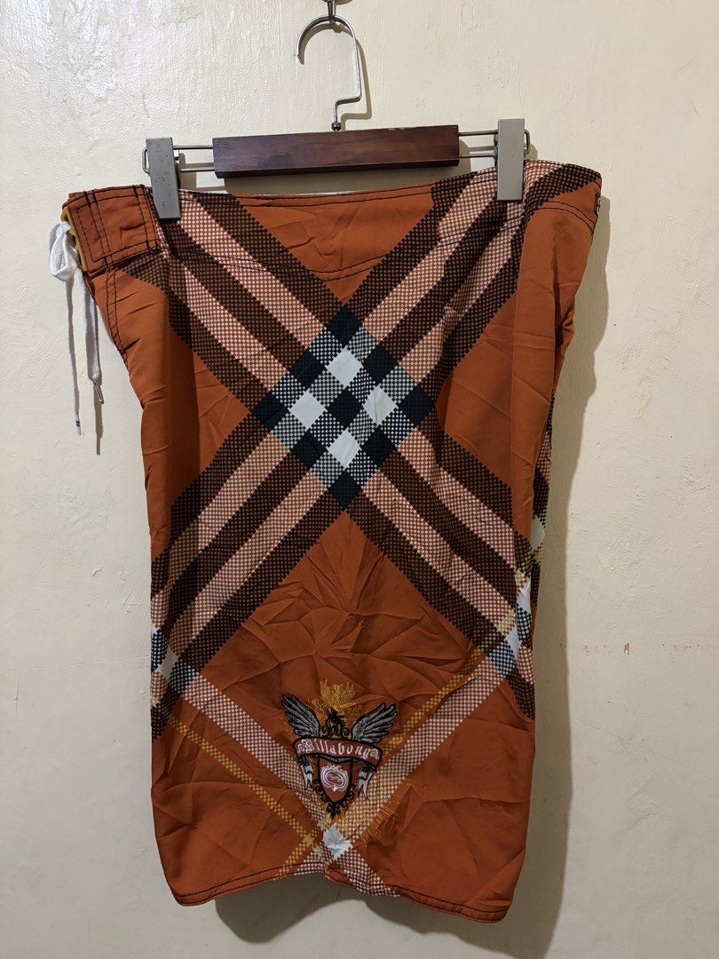 Billabong Board Shorts Orange Plaid Pattern (Category: Swim Trunks & Board Shorts) located in Bolinao. Submitted by ymondceleste (Listing ID 1460055555, Image 1). Description: - Orange board shorts with a classic plaid pattern. - Features the iconic Billabong logo embroidered on the pocket and back. - Comfortable drawstring waist for a secure fit. - Convenient back pocket with a button closure. - Ideal for swimming, surfing, or everyday casual we