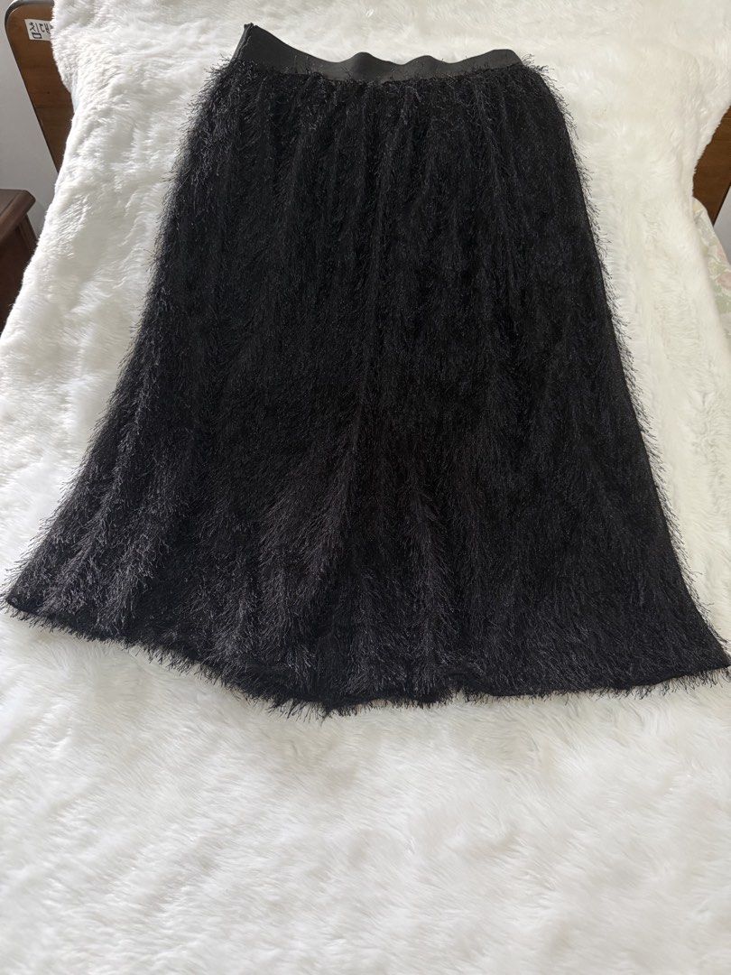 Black Feather Tassel Midi Skirt (Category: Skirts) located in Quezon City. Submitted by jezjewels.ph (Listing ID 1459979494, Image 1). Description: - Chic black midi skirt - Features a playful feather tassel texture - Comfortable elastic waistband - Mid-calf length - Ideal for parties, nights out, or making a statement.