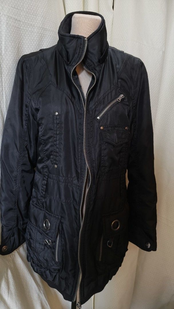Black Jacket with Multiple Zippers and Pockets (Category: Coats, Jackets and Outerwear) located in Taguig. Submitted by ymicloset (Listing ID 1459956684, Image 1). Description: - Stylish black jacket with an edgy look. - Multiple zippered pockets on the front for secure storage. - Additional button pockets and unique ring details. - Stand-up collar with a comfortable ribbed trim. - Full zipper closure down the front. - Versatile for layering or w