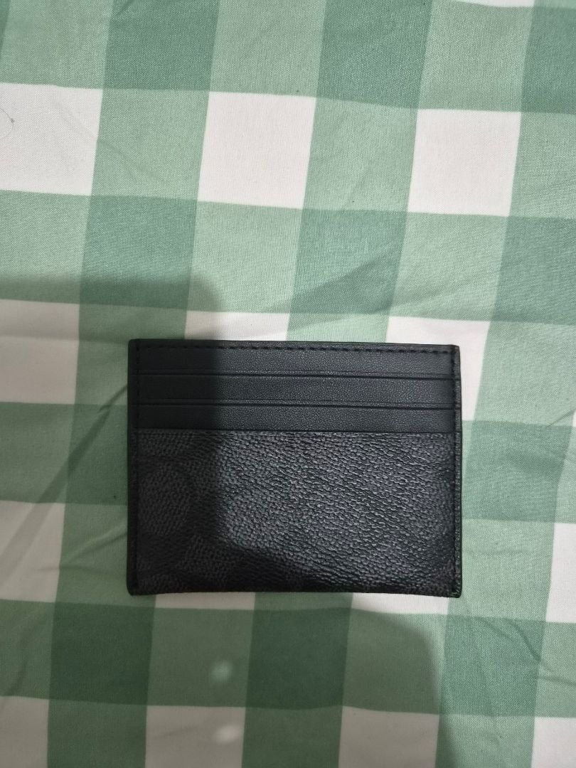 Black Leather Cardholder (Category: Wallets & Card holders) located in Paranaque City. Submitted by regf_01 (Listing ID 1459994342, Image 1). Description: Like new authentic Simple black Coach cardholder. Textured leather on one side, smooth on the other. Multiple card slots. Slim design, fits easily in pockets. Great for carrying essentials. No flaws, no issues in mint condition.