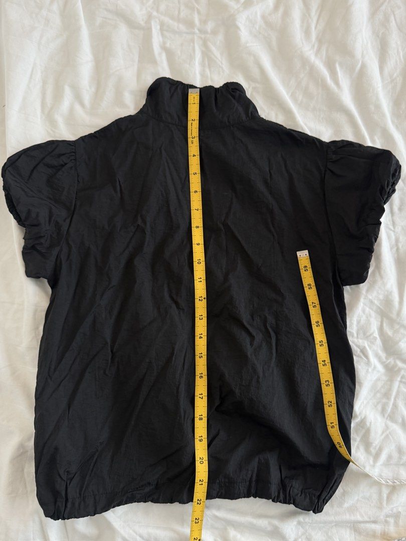 Black nylon zip up puff sleeve top (Category: Shirts) located in Mandaluyong City. Submitted by outofstoragewtf (Listing ID 1459992217, Image 3). Description: - size xs - bought from south korea - black nylon material - zip up detail - measurements on photos .