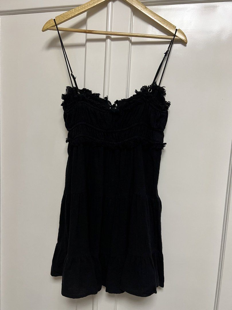 Black Ruffled Tiered Mini Dress with Tie Front (Category: Dresses) located in Paranaque City. Submitted by dubaichocolei (Listing ID 1460063254, Image 2). Description: - Black mini dress - Spaghetti straps - Ruffled neckline and hem - Smocked bust with tie detail - Tiered skirt design - Versatile for night out or casual wear.