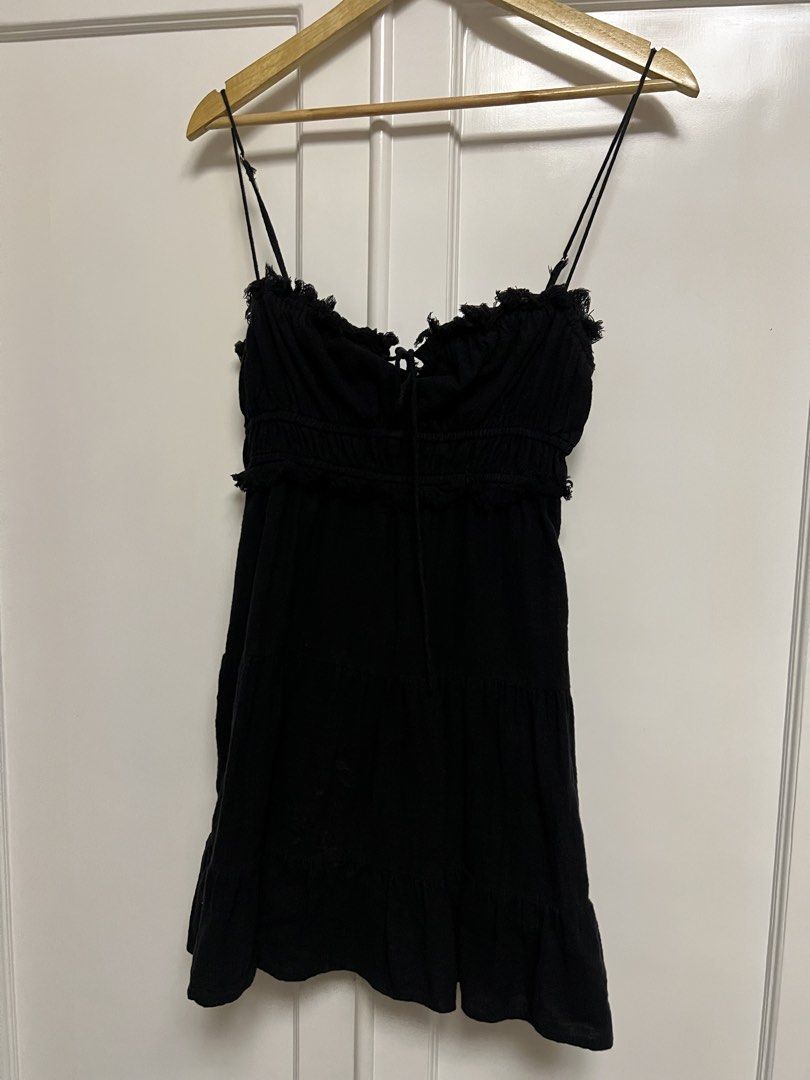 Black Ruffled Tiered Mini Dress with Tie Front (Category: Dresses) located in Paranaque City. Submitted by dubaichocolei (Listing ID 1460063254, Image 1). Description: - Black mini dress - Spaghetti straps - Ruffled neckline and hem - Smocked bust with tie detail - Tiered skirt design - Versatile for night out or casual wear.