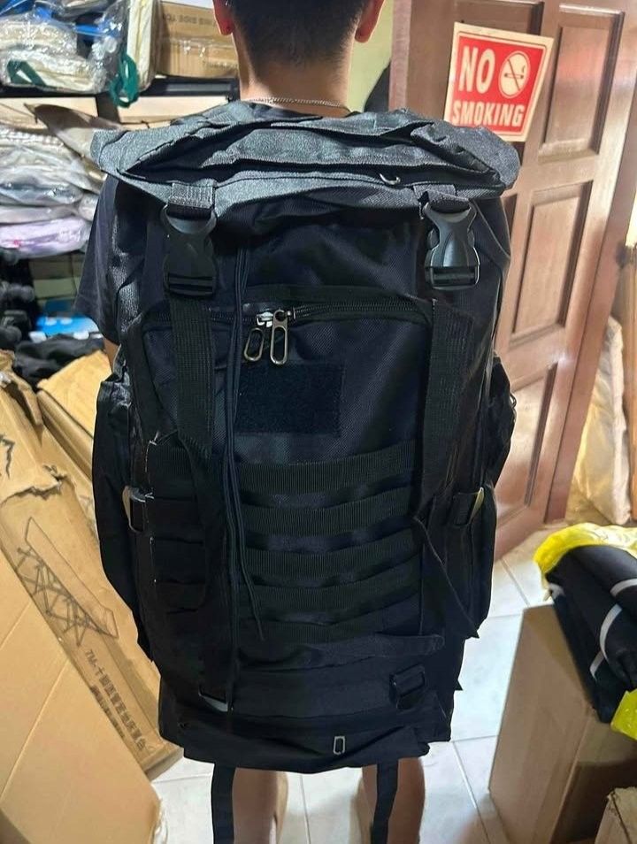 Black Tactical Backpack / Outdoor Hiking Backpack (Category: Backpacks) located in Manila. Submitted by zealdeer_5f4b49 (Listing ID 1460056365, Image 3). Description: - Large black backpack - Multiple compartments and pockets for organization - MOLLE webbing on front and sides for customizable gear attachment - Adjustable straps for a comfortable fit - Ideal for outdoor activities, travel, or everyday use - Made with durable material - Smooth wor