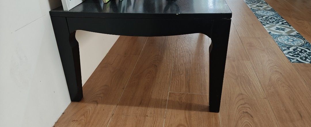 Black Wooden Coffee Table (Category: Tables & Sets) located in Manila. Submitted by teng_d (Listing ID 1459985584, Image 2). Description: - Simple black wooden coffee table. originally white,professionally painted to black - Minor chips and scuffs on edges (visible in photos) -fashionably curved legs, very stable - bought from good store in mall - Ideal for living room - Approximate dimensions: length: 110 cm ht: 38cm width:60 cm.