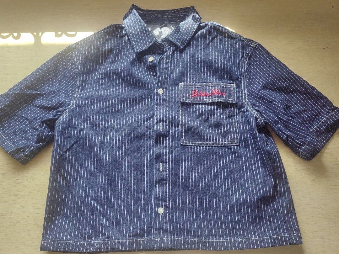 Blue Pinstripe Button-Up Shirt (Category: Tshirts & Polo Shirts ) located in Quezon City. Submitted by brycine022416 (Listing ID 1460073189, Image 1). Description: - Classic blue shirt with white pinstripes - Chest pocket with red embroidery - Button-up front and collar - Versatile for casual or work attire Available - Dark Blue - Light Blue 400 each, take both for 700.