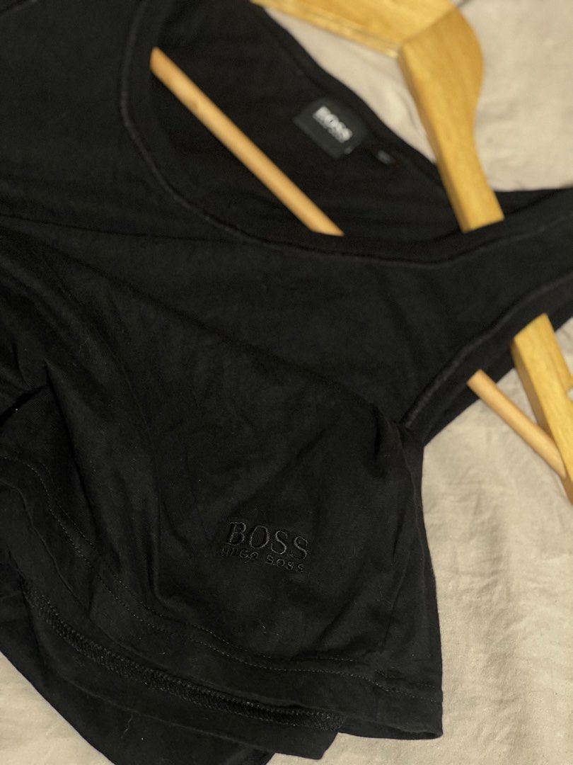 BOSS Hugo Boss Black Tank Top (Category: Sleep and Loungewear) located in Marikina City. Submitted by joshuaades21107 (Listing ID 1460084729, Image 1). Description: - Classic black BOSS Hugo Boss tank top - Simple and versatile design - Soft and comfortable material - Ideal for layering or wearing on its own - Features a subtly embroidered BOSS logo on the chest.