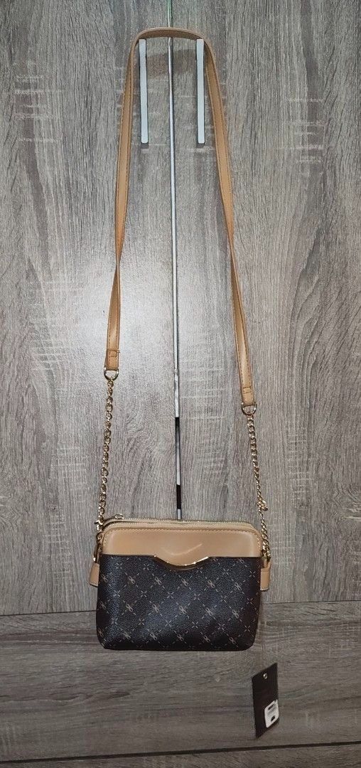 Brown Crossbody Bag with Gold Chain (Category: Cross-body Bags) located in Taguig. Submitted by regisme (Listing ID 1460095578, Image 2). Description: Unused crossbody bag 👜 - 2 zippers, 1 front pocket - leather with chain straps Price: P750 + Shipping Fee Payment: GCash / BPI.
