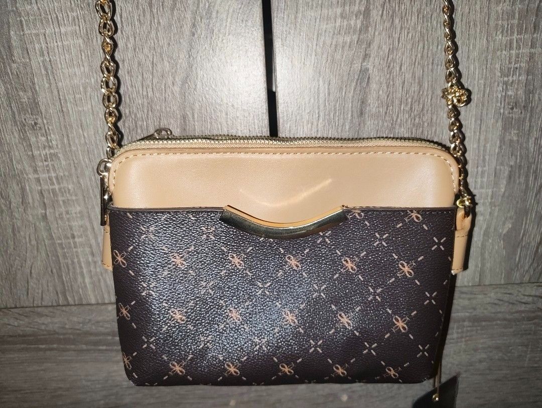 Brown Crossbody Bag with Gold Chain (Category: Cross-body Bags) located in Taguig. Submitted by regisme (Listing ID 1460095578, Image 1). Description: Unused crossbody bag 👜 - 2 zippers, 1 front pocket - leather with chain straps Price: P750 + Shipping Fee Payment: GCash / BPI.