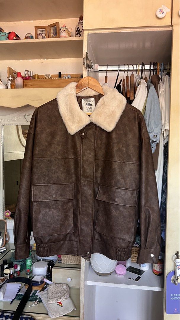 Brown Faux Leather Shearling Collar Bomber Jacket (Category: Coats, Jackets and Outerwear) located in Quezon City. Submitted by trishqry (Listing ID 1459973176, Image 2). Description: - Stylish brown faux leather bomber jacket - Cozy shearling collar for warmth - Two front pockets with secure button closures - Convenient zip-up front - Elasticated cuffs and hem for a comfortable, snug fit - Ideal for cooler weather - Versatile: pairs well with je