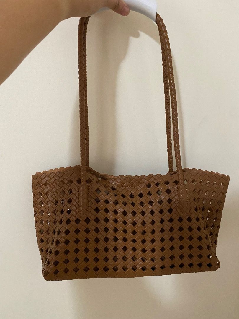 Brown Woven Tote Bag (Category: Tote Bags) located in Angeles City. Submitted by raintree.lorenzo (Listing ID 1459913134, Image 2). Description: - Stylish brown woven tote bag - Features unique diamond-shaped cutouts - Comfortable braided handles - Ideal for everyday errands or beach outings - Spacious interior to carry your essentials.