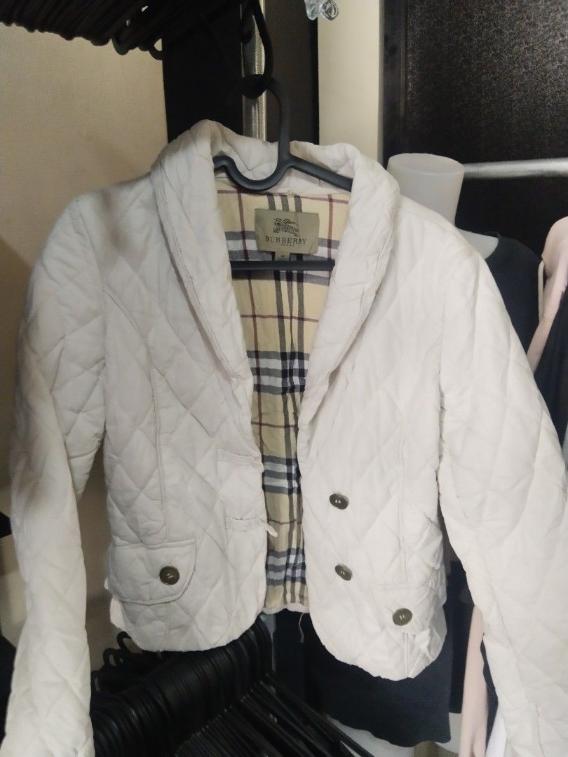 Burberry Quilted Jacket - White (Category: Coats, Jackets and Outerwear) located in Manila. Submitted by mr_thrifty13 (Listing ID 1459999294, Image 2). Description: - Authentic Burberry quilted jacket in white. - Iconic Nova Check lining inside. - Classic button-down front with convenient pockets. - Tagged as Medium, but fits more like a Small (please check measurements)..