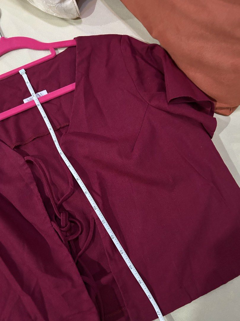 Burgundy Cropped Tie Blouse (Category: Blouses) located in Cainta. Submitted by unboxingstuff (Listing ID 1460048275, Image 3). Description: - Burgundy cropped top with ties - Short sleeves - Textured fabric; linen mix - Measurements: Approx. 15" chest, 17" length - Ideal for layering over tops or dresses.