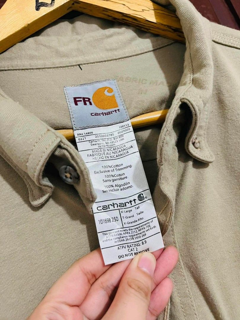 CARHARTT FR WORK SHIRT (Category: Coats, Jackets and Outerwear) located in Pagsanjan. Submitted by thriftyclothes33 (Listing ID 1460062385, Image 3). Description: CARHARTT FR WORK SHIRT 🟤🔥 💰 ₱750 + SF 🛠️ Flame-Resistant (FR) work shirt ⚡ Utility / workwear style 🏷️ NV Energy employee customization 🪡 Carhartt logo patch 🧥 Button-front design 🎨 Classic khaki color 🏷️ XL on tag — best fit 2XL 📏 Width 27" • Length 33" 👍🏻 VeryGood conditio