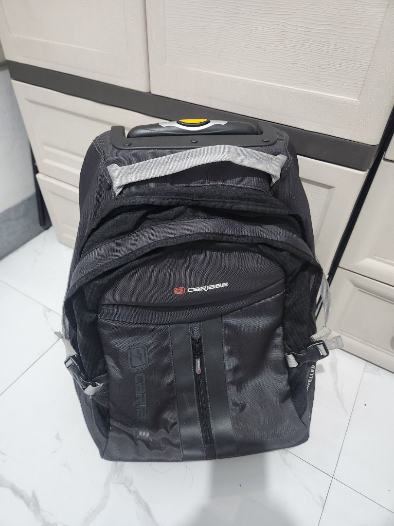 Caribee Rolling Backpack Luggage (Category: Backpacks) located in Pila. Submitted by mica.zaldivia (Listing ID 1460089191, Image 2). Description: - Black Caribee rolling backpack - Features wheels and retractable handle for easy transport - Multiple compartments for ample storage - Ideal for travel or school use - Shows some signs of wear on wheels and handle, but fully functional - Please check photos for detailed condition.