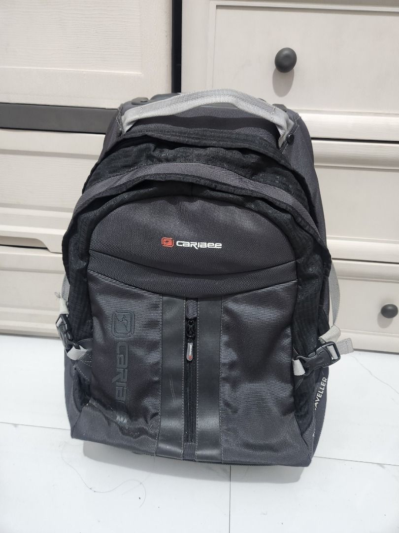 Caribee Rolling Backpack Luggage (Category: Backpacks) located in Pila. Submitted by mica.zaldivia (Listing ID 1460089191, Image 3). Description: - Black Caribee rolling backpack - Features wheels and retractable handle for easy transport - Multiple compartments for ample storage - Ideal for travel or school use - Shows some signs of wear on wheels and handle, but fully functional - Please check photos for detailed condition.