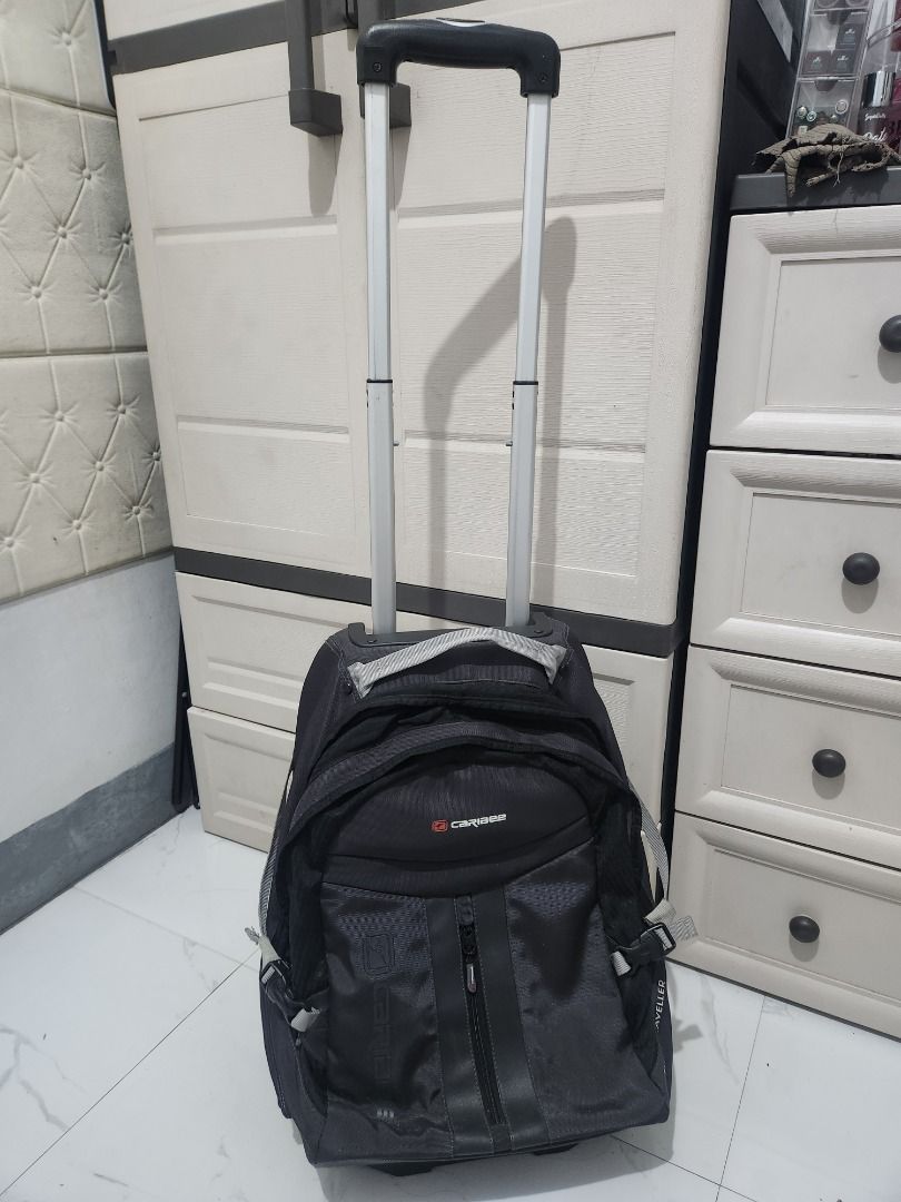 Caribee Rolling Backpack Luggage (Category: Backpacks) located in Pila. Submitted by mica.zaldivia (Listing ID 1460089191, Image 1). Description: - Black Caribee rolling backpack - Features wheels and retractable handle for easy transport - Multiple compartments for ample storage - Ideal for travel or school use - Shows some signs of wear on wheels and handle, but fully functional - Please check photos for detailed condition.