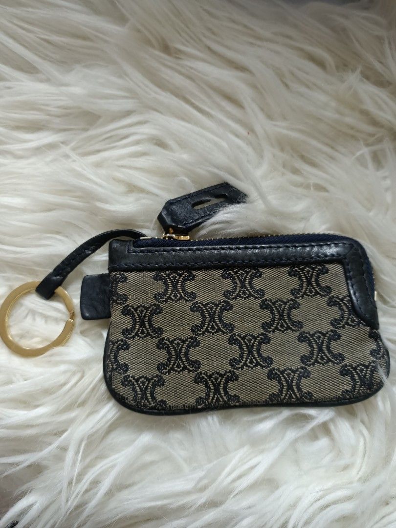 Celine Monogram Canvas Coin Pouch with Keychain (Category: Luxury Bags & Wallets) located in Bayombong. Submitted by rheaaa00530 (Listing ID 1460069585, Image 1). Description: - Authentic Celine coin pouch - Classic monogram canvas pattern - Black leather trim and details - Zipper closure - Red fabric interior lining - Includes gold-tone keychain - Compact size, ideal for coins or small items.