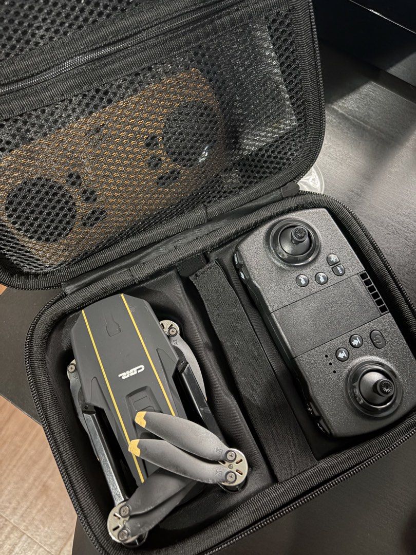 CGR Foldable Drone with Remote Controller and Case (Category: Drones) located in Manila. Submitted by cawee_polyeevee (Listing ID 1460095396, Image 1). Description: - CGR foldable drone in black with yellow accents - Foldable arms for easy portability - Comes with a black remote controller - Includes a protective carrying case for storage and transport - Ideal for beginner pilots and casual flying.