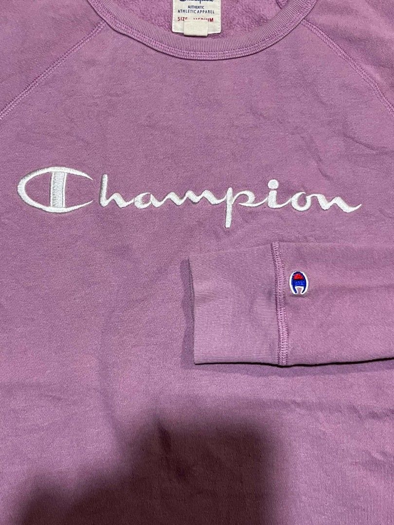 Champion Authentic Athletic Apparel Sweatshirt - Medium - Purple (Category: Coats, Jackets and Outerwear) located in Taguig. Submitted by 22nd_street_thrift (Listing ID 1460036347, Image 2). Description: - Champion raglan sleeve sweatshirt - Color: Purple - White Champion logo across the chest - Small C logo on the left sleeve cuff - Size: Medium - Made in China.