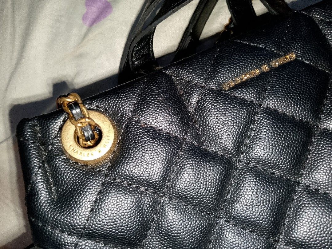 Charles & Keith Black Quilted Chain Backpack (Category: Backpacks) located in Bulacan. Submitted by cheolsimp17 (Listing ID 1459936111, Image 3). Description: - Black quilted backpack from Charles & Keith - Features gold chain straps and hardware - Secure zip closure - Versatile for everyday use or evening outings - can lower pa yung price just dm me loc. Bulacan.
