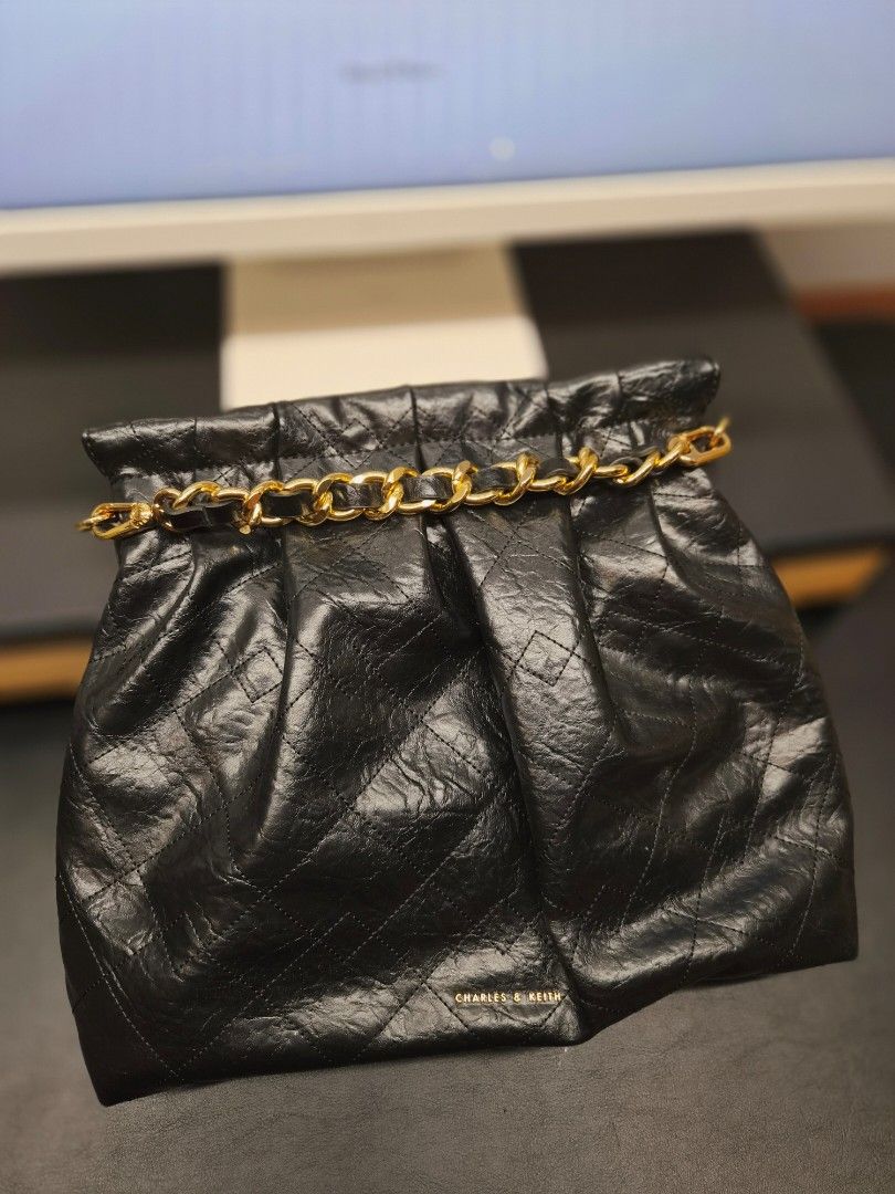 Charles & Keith Black Quilted Chain Shoulder Bag (Category: Shoulder Bags) located in Taytay. Submitted by allthingslove_riz (Listing ID 1460019700, Image 2). Description: - Brand: Charles & Keith - Style: Quilted Shoulder Bag - Color: Black - Material: Crinkled texture - Hardware: Gold chain strap - Closure: Zipper - Versatile: Great for casual or dressy looks Such a steal! In really great shape. Used 2x only! Comes with its original dust bag..