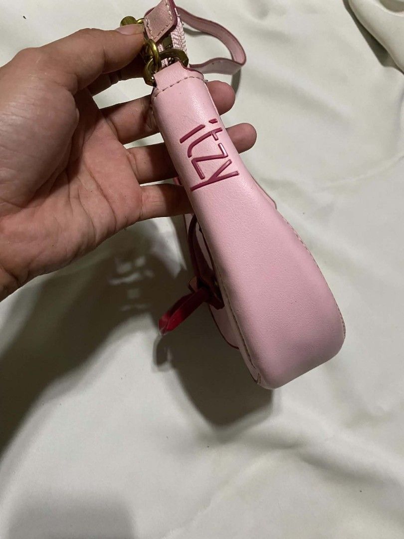 Charles & Keith Pink Shoulder Bag with ITZY Charm (Category: Shoulder Bags) located in Taguig. Submitted by althriftdailyloots94 (Listing ID 1460040324, Image 2). Description: - Cute pink shoulder bag from Charles & Keith - Features a small strap and secure buckle closure - Bright pink interior - Adorable 'ITZY' charm attached - Perfect for carrying your essentials - Zippers are in good working condition - Minor signs of wear on edges, overall st