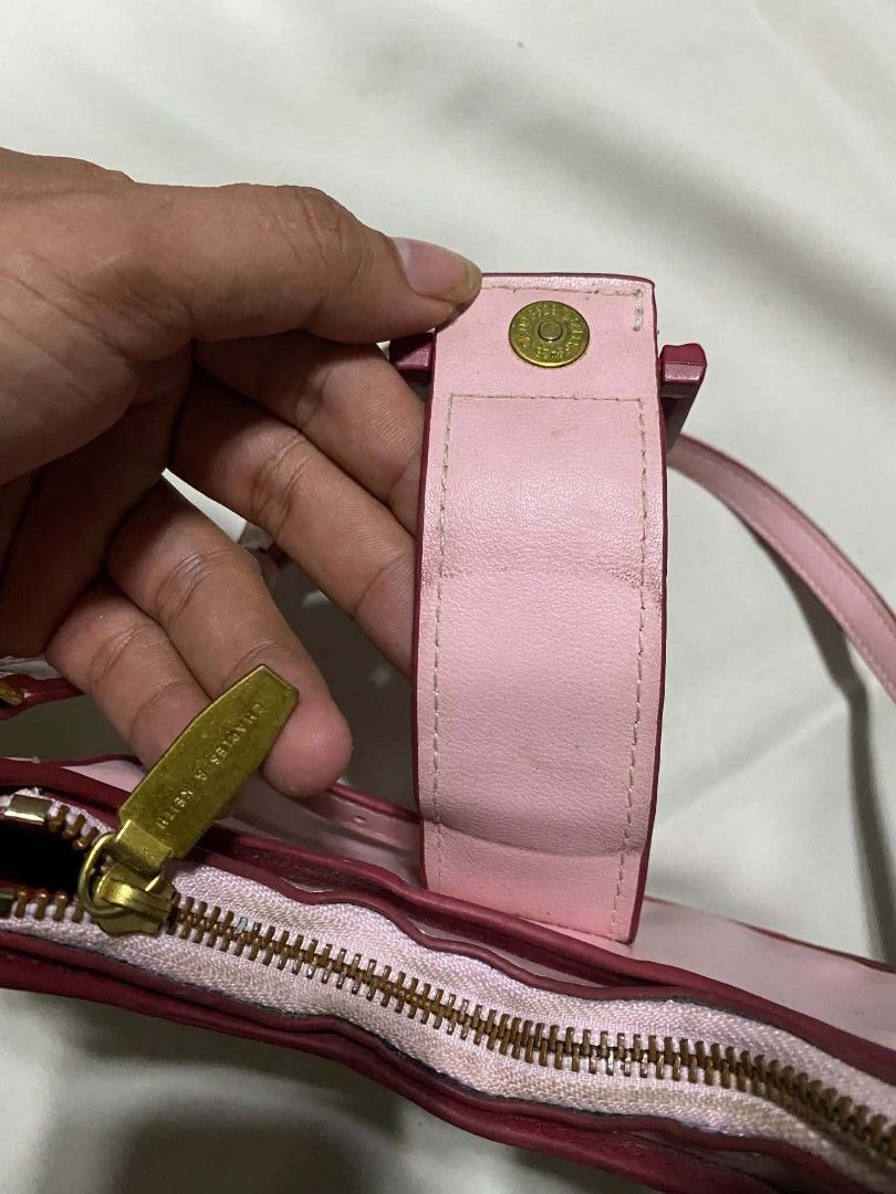 Charles & Keith Pink Shoulder Bag with ITZY Charm (Category: Shoulder Bags) located in Taguig. Submitted by althriftdailyloots94 (Listing ID 1460040324, Image 3). Description: - Cute pink shoulder bag from Charles & Keith - Features a small strap and secure buckle closure - Bright pink interior - Adorable 'ITZY' charm attached - Perfect for carrying your essentials - Zippers are in good working condition - Minor signs of wear on edges, overall st