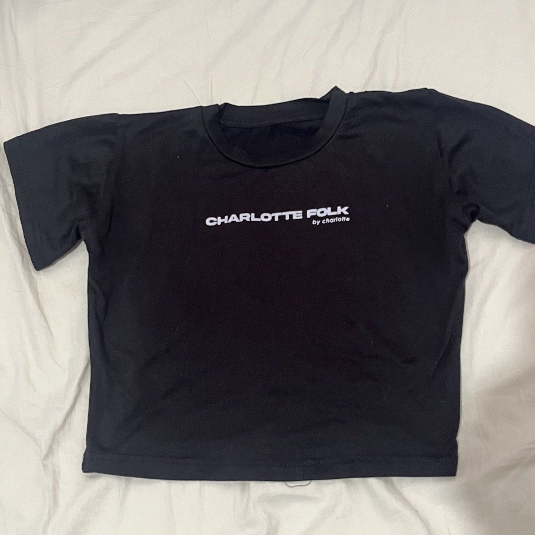 Charlotte Folk Black Baby Tee (Category: Shirts) located in Manila. Submitted by julianasclozet (Listing ID 1459909899, Image 1). Description: - Brand: Charlotte Folk by Charlotte - Style: Cropped T-shirt - Color: Black - Features: Short sleeves, crew neck - Occasion: Casual wear - Versatility: Easy to pair with jeans or skirts.