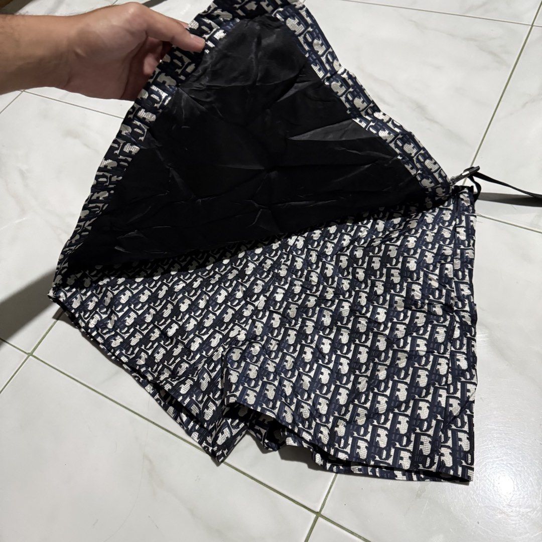 Christian Dior All-Over Logo Shorts (Category: Shorts) located in Manila. Submitted by preciousma24494 (Listing ID 1460020258, Image 2). Description: - Iconic Christian Dior all-over logo print size:28 - Dark blue and white colorway - Black buckle detail and drawstring - Lined interior - Perfect statement piece for a bold look.