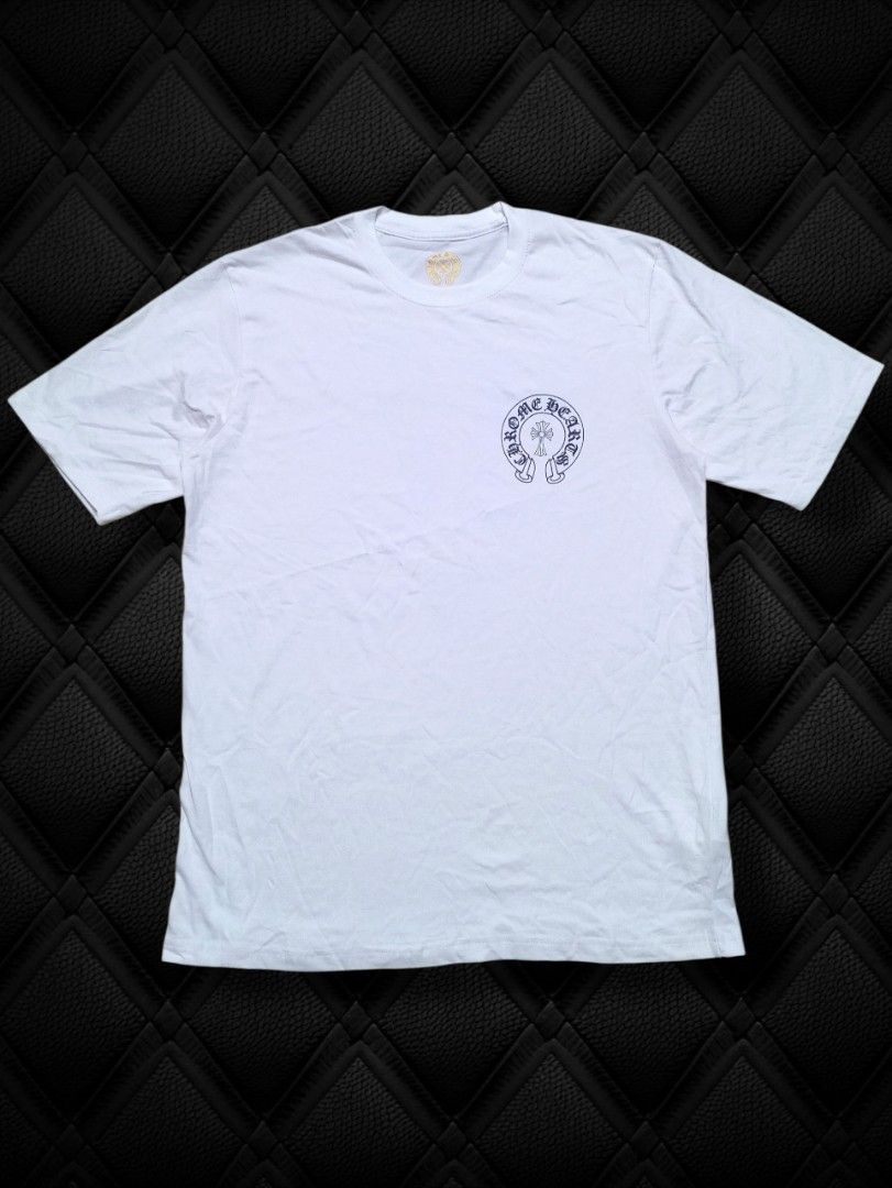 Chrome Hearts White T-Shirt I Tee (Category: Tshirts & Polo Shirts ) located in Aguinaldo. Submitted by baguioukayukay2600 (Listing ID 1459923495, Image 2). Description: - White Chrome Hearts T-shirt - Features the iconic Chrome Hearts cross logo on the back - Gradient color fill on the back logo for a unique look - Small Chrome Hearts logo detail on the front chest - Made from comfortable, breathable cotton material - Ideal for everyday casual w