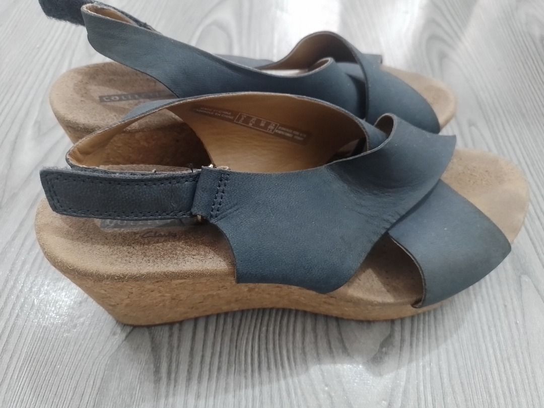 Clarks Collection Blue Leather Wedge Sandals³ (Category: Wedges) located in General Trias. Submitted by belinajg (Listing ID 1459978134, Image 3). Description: - Clarks Collection blue leather slingback sandals - Size 7 US - Crossover strap design - Comfortable cork wedge sole - Adjustable heel strap for a secure fit - Perfect for stylish everyday wear.