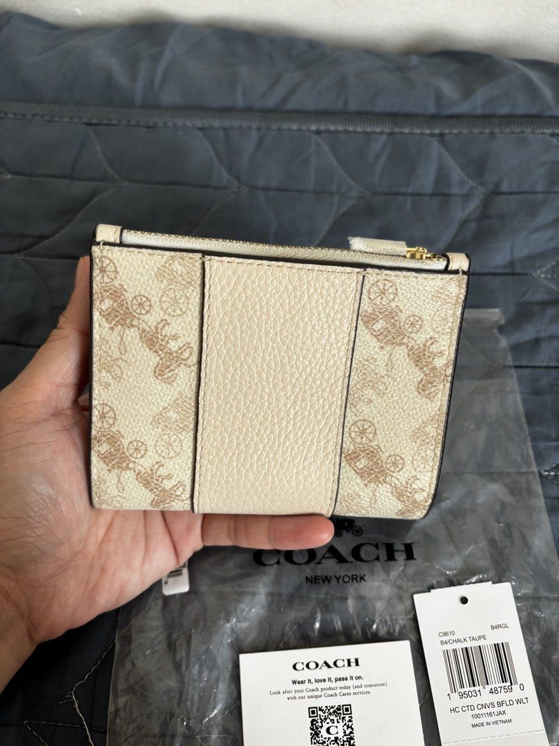 Coach Bifold Wallet (Category: Wallets & Card holders) located in Manila. Submitted by declutter_byjaq (Listing ID 1459971922, Image 3). Description: Coach Horse & Carriage Bifold Wallet Code: C9610 Color: Chalk Taupe With Tag,Care Card and Poly plastic From US RFS: Needs Cash.
