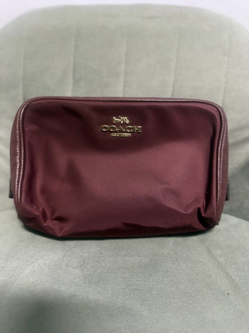 Coach Cosmetic Bag Burgundy (Category: Luxury Bags & Wallets) located in Quezon City. Submitted by karlalorde (Listing ID 1460043163, Image 1). Description: - Deep burgundy Coach cosmetic bag - Features gold Coach logo and New York detail - Made of nylon with leather trim - Ideal size for makeup or toiletries - Perfect for travel or everyday use.