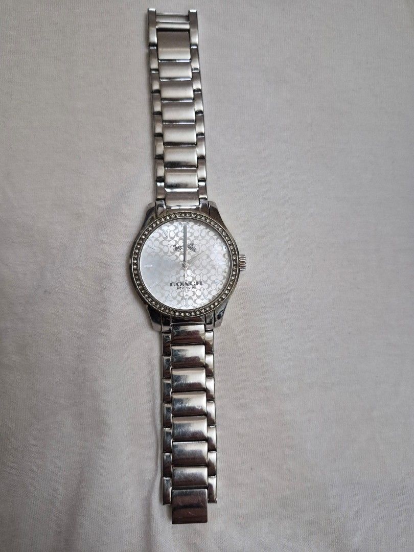 Coach Ladies Stainless Watch (Category: Women's Watches) located in Manila. Submitted by goldenphoenix_1e67c6 (Listing ID 1459967485, Image 3). Description: Brand: Coach New York Color: Silver Stainless steel bracelet White Coach signature-pattern dial Crystal/studded bezel design Comes with Coach box Pre-owned / gently used Watch is in good overall condition; please see photos for actual condition Bracelet may need adjustment depending on wrist 