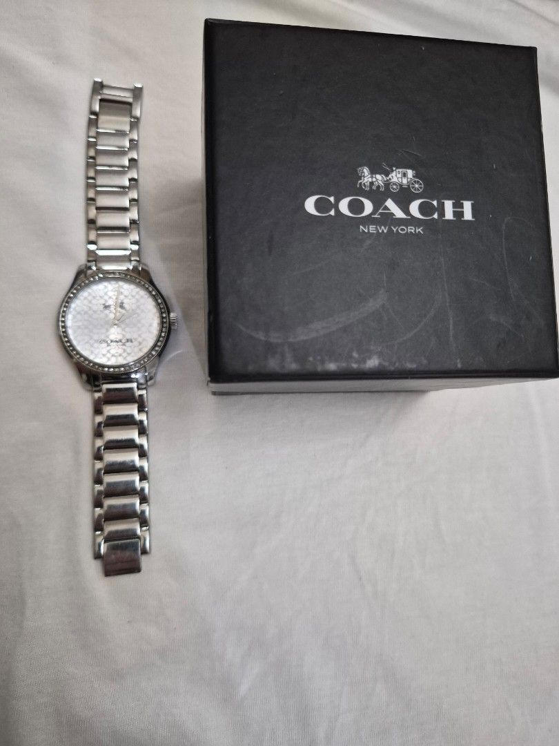 Coach Ladies Stainless Watch (Category: Women's Watches) located in Manila. Submitted by goldenphoenix_1e67c6 (Listing ID 1459967485, Image 1). Description: Brand: Coach New York Color: Silver Stainless steel bracelet White Coach signature-pattern dial Crystal/studded bezel design Comes with Coach box Pre-owned / gently used Watch is in good overall condition; please see photos for actual condition Bracelet may need adjustment depending on wrist 