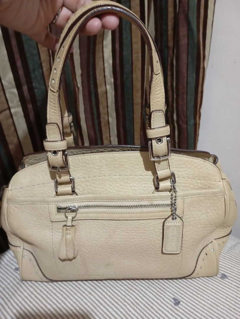 Coach Leather Handbag Beige (Category: Luxury Bags & Wallets) located in Manila. Submitted by marjvergar92936 (Listing ID 1460095447, Image 3). Description: - Authentic Coach bag - Material: Soft Pebbled Leather Tassel Satchel - Color: Beige - Features: Zippered main compartment, front zip pocket - Interior: Coach creed tag - Condition: Good as new - Perfect for everyday use.