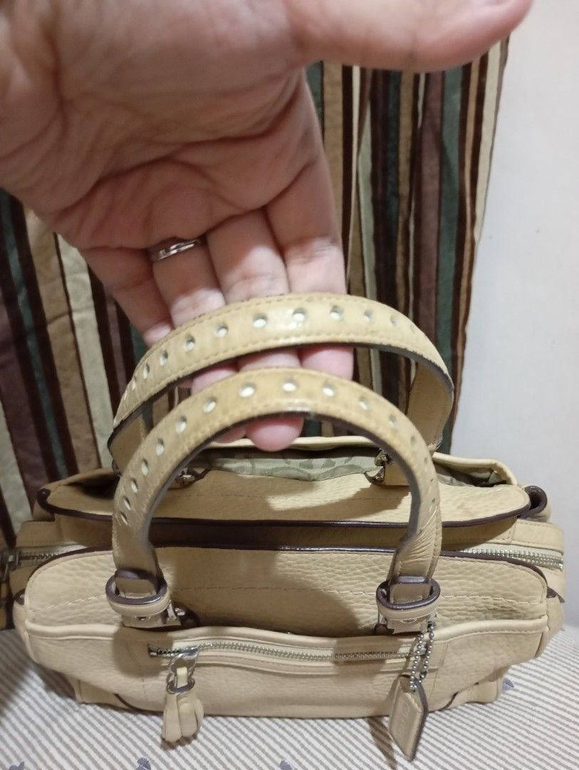 Coach Leather Handbag Beige (Category: Luxury Bags & Wallets) located in Manila. Submitted by marjvergar92936 (Listing ID 1460095447, Image 2). Description: - Authentic Coach bag - Material: Soft Pebbled Leather Tassel Satchel - Color: Beige - Features: Zippered main compartment, front zip pocket - Interior: Coach creed tag - Condition: Good as new - Perfect for everyday use.