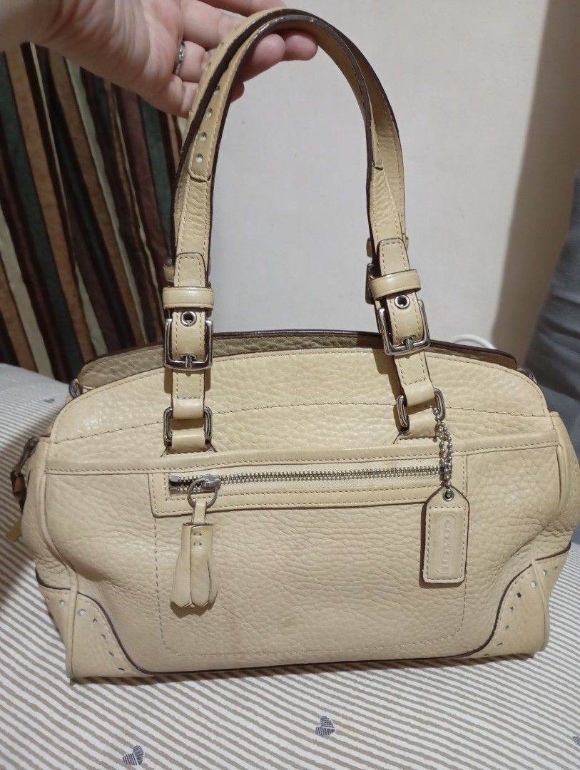 Coach Leather Handbag Beige (Category: Luxury Bags & Wallets) located in Manila. Submitted by marjvergar92936 (Listing ID 1460095447, Image 1). Description: - Authentic Coach bag - Material: Soft Pebbled Leather Tassel Satchel - Color: Beige - Features: Zippered main compartment, front zip pocket - Interior: Coach creed tag - Condition: Good as new - Perfect for everyday use.
