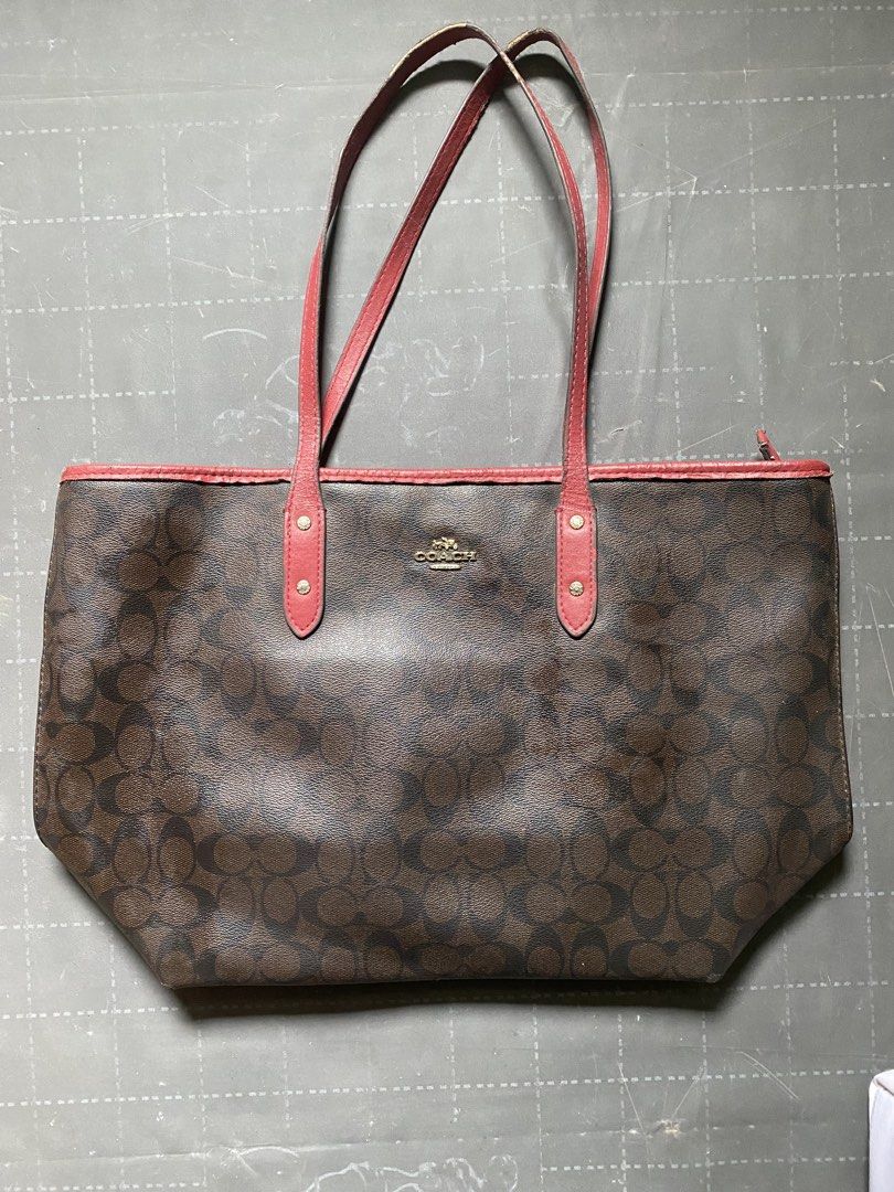 Coach Monogram Tote Bag with Red Trim (Category: Luxury Bags & Wallets) located in Zamboanga. Submitted by trippsnthrifts (Listing ID 1460053676, Image 1). Description: - Classic Coach tote bag - Brown monogram print with red leather trim and handles - Secure zip top closure - Spacious interior for essentials - Perfect for everyday use or travel - Shows some signs of wear on handles and trim.