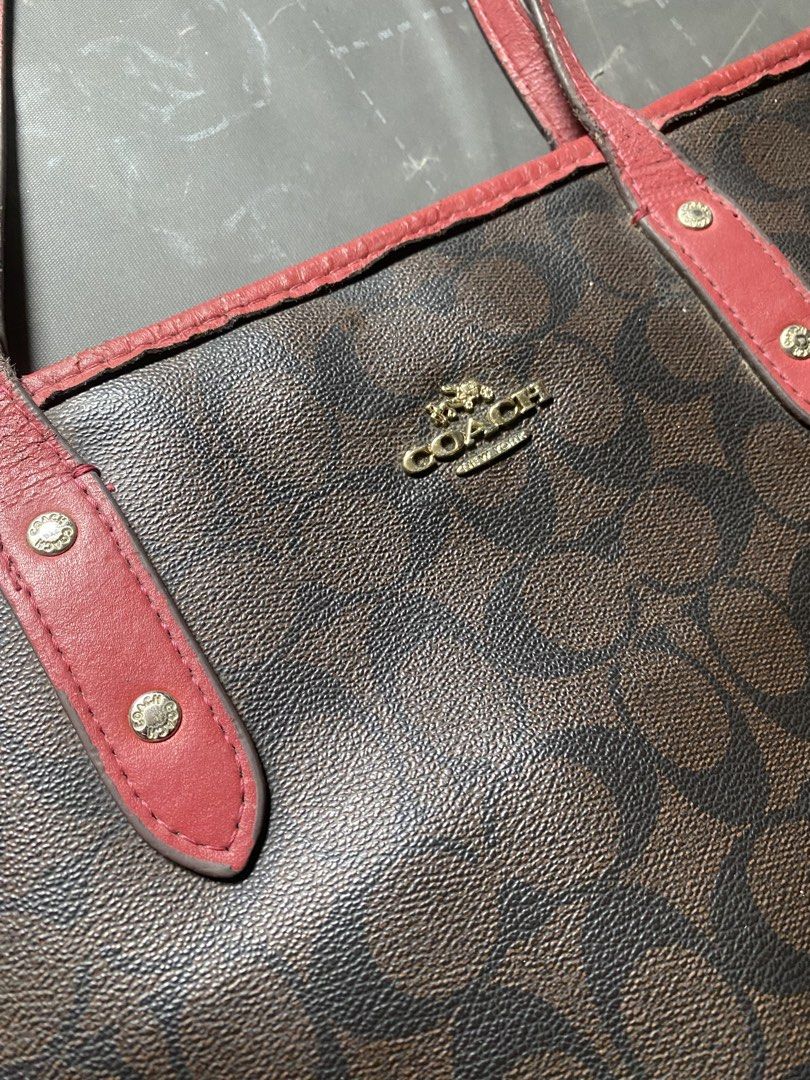 Coach Monogram Tote Bag with Red Trim (Category: Luxury Bags & Wallets) located in Zamboanga. Submitted by trippsnthrifts (Listing ID 1460053676, Image 2). Description: - Classic Coach tote bag - Brown monogram print with red leather trim and handles - Secure zip top closure - Spacious interior for essentials - Perfect for everyday use or travel - Shows some signs of wear on handles and trim.