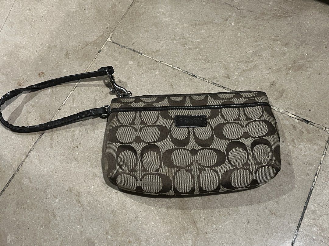 Coach Signature C Monogram Canvas Wristlet Pouch (Category: Luxury Bags & Wallets) located in Makati City. Submitted by aliyahprieto949 (Listing ID 1460019129, Image 1). Description: - Authentic Coach wristlet - Classic brown and tan signature C monogram pattern - Genuine leather trim and wrist strap - Secure zipper closure - Compact size, perfect for essentials (cards, cash, phone) - Versatile for quick errands or nights out.