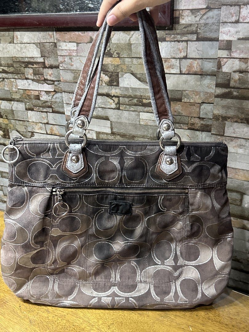 Coach Signature Monogram Tote Bag (Category: Luxury Bags & Wallets) located in Manila. Submitted by keiscart_ (Listing ID 1460059117, Image 1). Description: - Authentic Coach tote bag - Classic brown and silver monogram pattern - Secure top zipper closure - Convenient front zipper pocket - Comfortable double shoulder straps - Ideal for everyday use and carrying your essentials.
