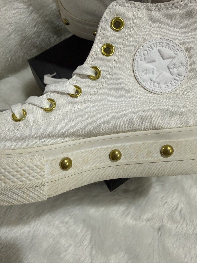 Converse Platform High-Top Sneakers White Gold Studs (Category: Sneakers) located in Quezon City. Submitted by jezjewels.ph (Listing ID 1460010865, Image 3). Description: Note: this is lightly used however there are yellow stains it was kept for a long time - White Converse high-top platform sneakers - Features gold eyelets and gold stud details along the platform - Includes original Converse box - Super cute and adds an edgy vibe to any outfit -