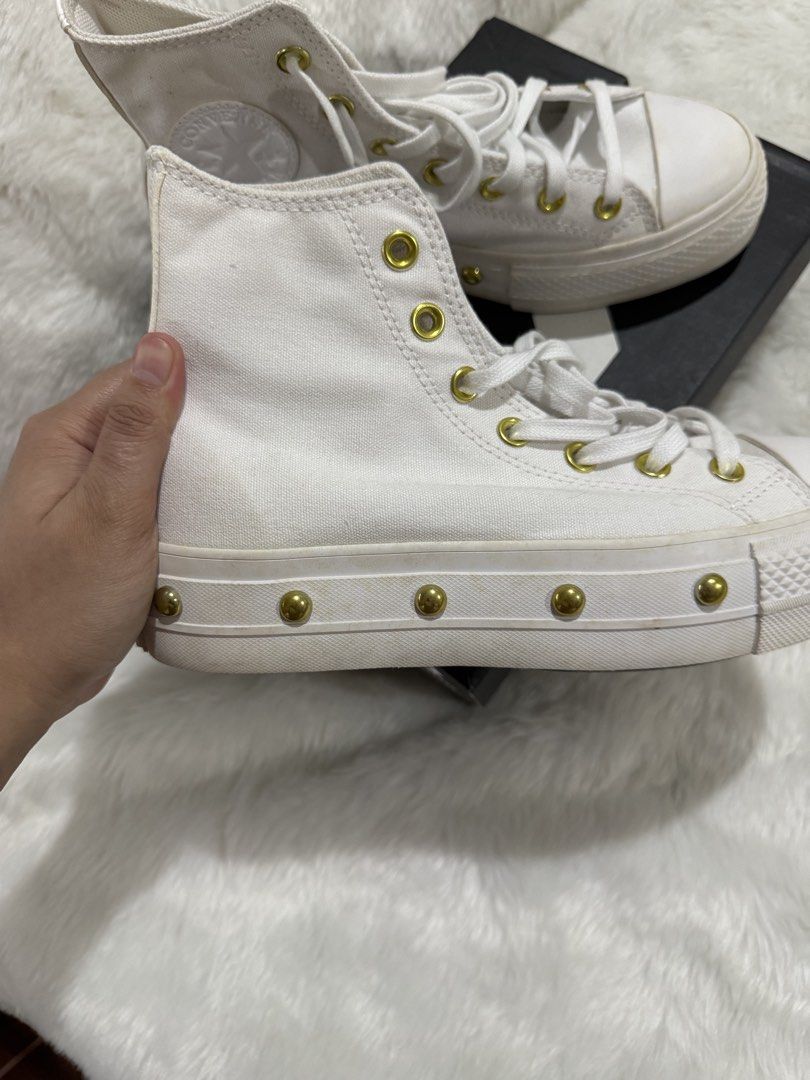 Converse Platform High-Top Sneakers White Gold Studs (Category: Sneakers) located in Quezon City. Submitted by jezjewels.ph (Listing ID 1460010865, Image 2). Description: Note: this is lightly used however there are yellow stains it was kept for a long time - White Converse high-top platform sneakers - Features gold eyelets and gold stud details along the platform - Includes original Converse box - Super cute and adds an edgy vibe to any outfit -