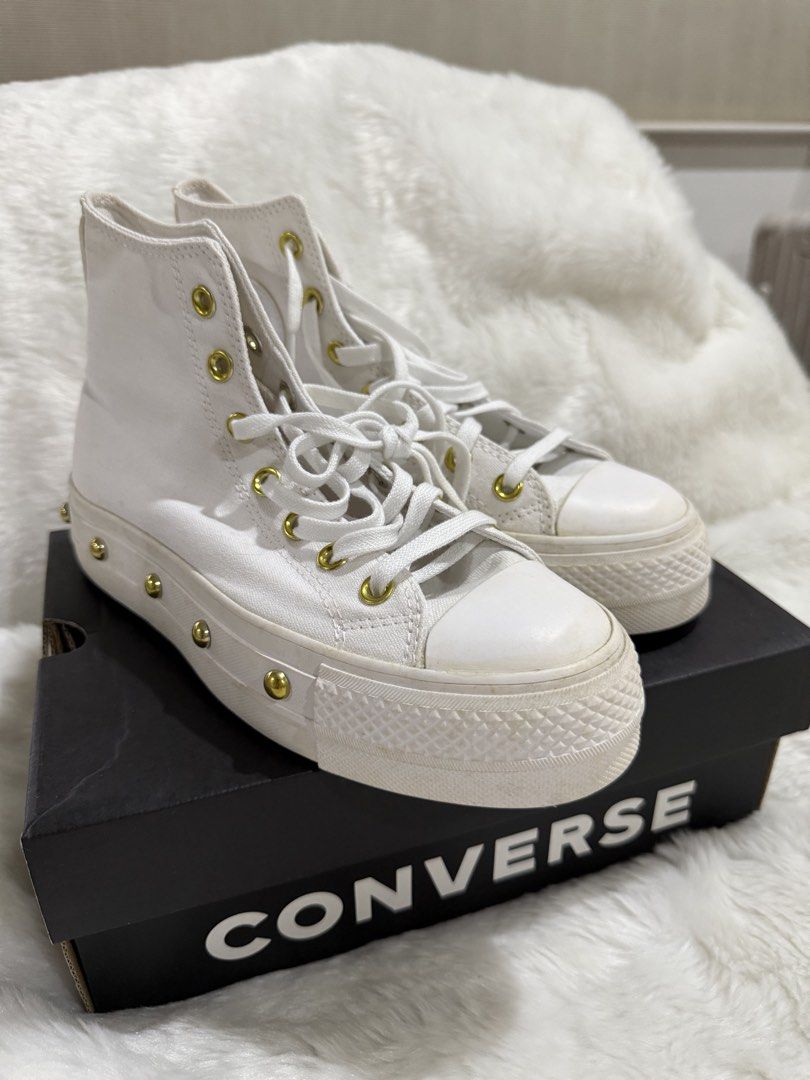 Converse Platform High-Top Sneakers White Gold Studs (Category: Sneakers) located in Quezon City. Submitted by jezjewels.ph (Listing ID 1460010865, Image 1). Description: Note: this is lightly used however there are yellow stains it was kept for a long time - White Converse high-top platform sneakers - Features gold eyelets and gold stud details along the platform - Includes original Converse box - Super cute and adds an edgy vibe to any outfit -