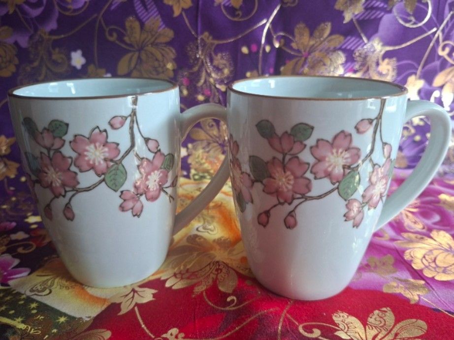 Corelle Coordinates Mug Set of 2 (Category: Coffee & Tea Tableware) located in Consolacion. Submitted by luxekerei (Listing ID 1457240256, Image 1). Description: - are Corelle Coordinates Cherry Blossom porcelain mugs featuring a delicate pink floral branch motif and a subtle brown rim.