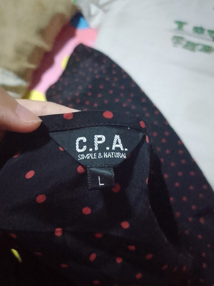 Black Polka Dot Top (Category: Blouses) located in Batangas. Submitted by sheenx.09 (Listing ID 1459929825, Image 2). Description: - L on tag (M to L) - pwedeng pang maternity dress 🥰 - Black top with charming red polka dots 😀 - Short sleeves with a subtle puff detail☺️ - Flattering V-neck with adjustable tie - Fabric boasts a lovely sheen - Ideal for casual wear 😉.