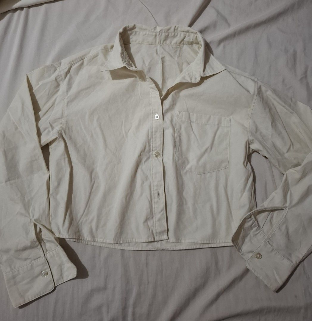 Cream Cropped Long Sleeve Button Up Shirt (Category: Longsleeves) located in Taguig. Submitted by plnmrtz (Listing ID 1460083347, Image 1). Description: - Cream colored cropped shirt - Long sleeves with button cuffs - Single pocket on left chest - Button up front - Versatile for layering or wearing alone - Bought from a thrift shop - Worn only once - RFS: Decluttering.